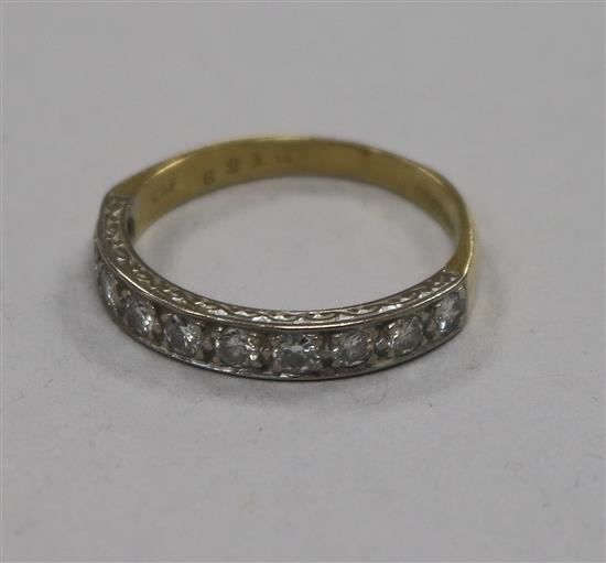 An early 1970s 18ct gold and ten stone diamond half eternity ring, size Q.